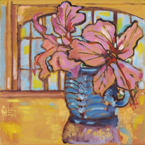 Pink hibiscus blossoms in a blue vase, a window behind.